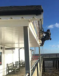 rope access technician working on pier 