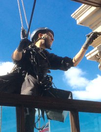 expert rope access technician painting work on treasury in london