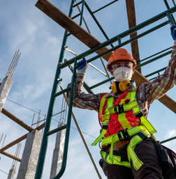 man hanging on scaffolding